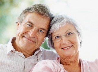 Closeup of a smiling cute senior couple sitting together